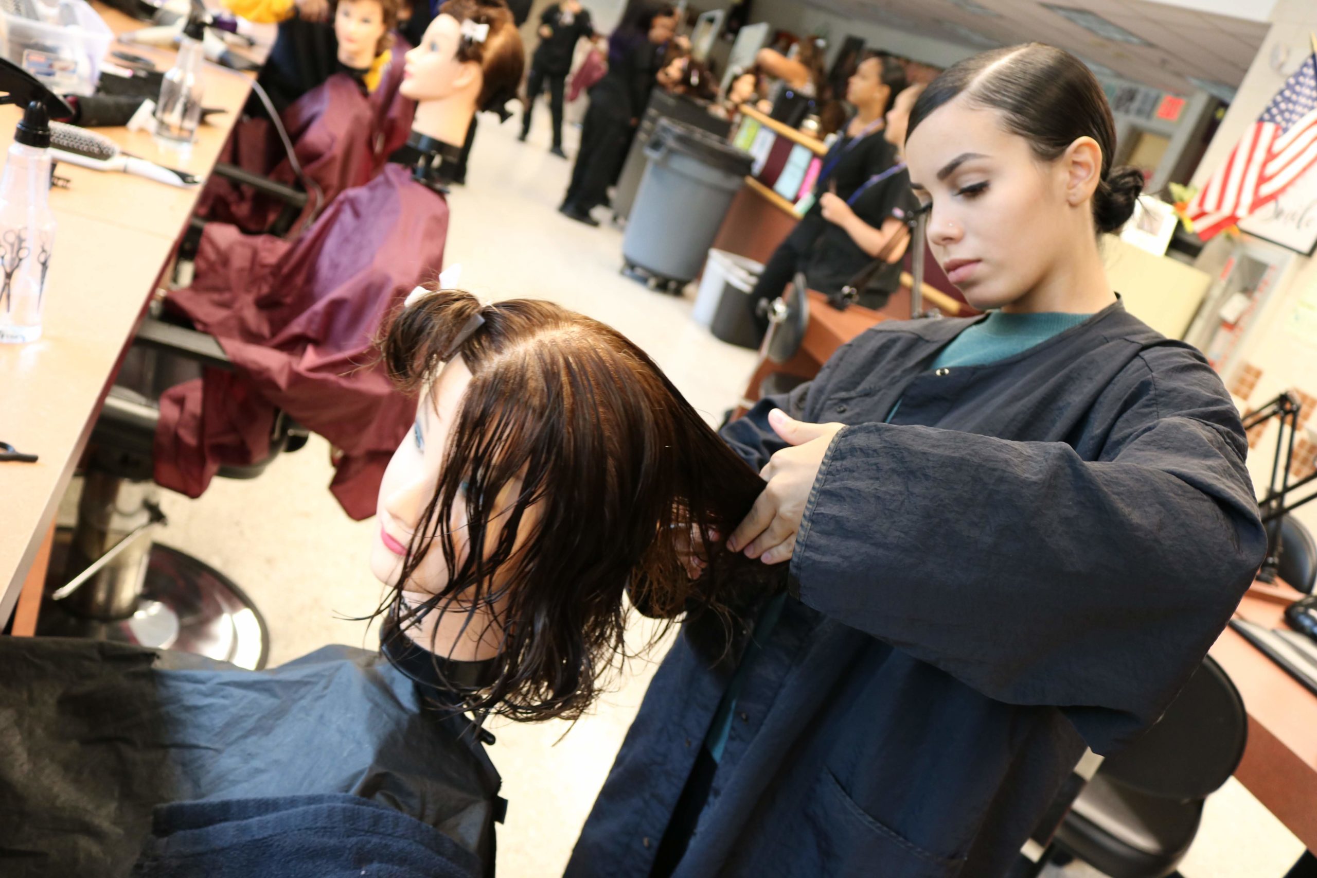 hairdressing student working on mannequin