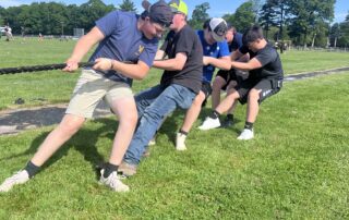 Students participate in tug of war in field day.
