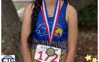 Izabella Diaz poses with her CTC XC medal.